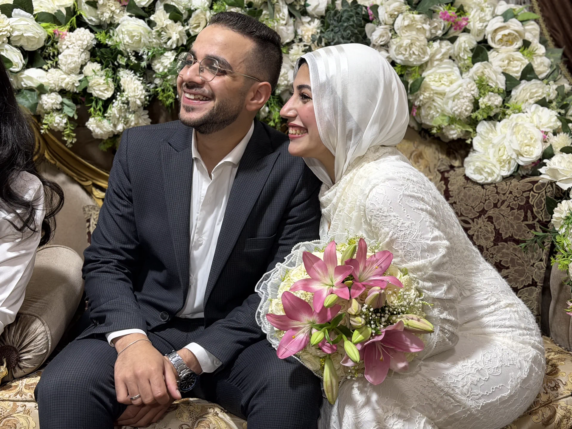 Ahmed and Rawan celebrating among white flowers