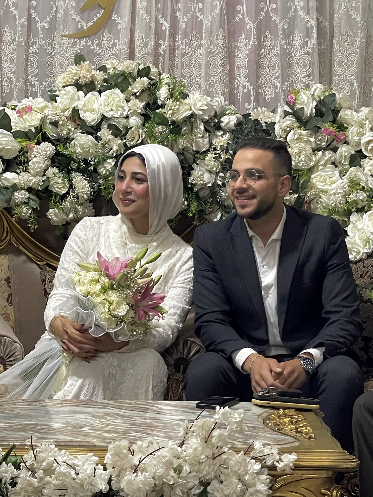 Ahmed and Rawan seated together at the wedding celebration