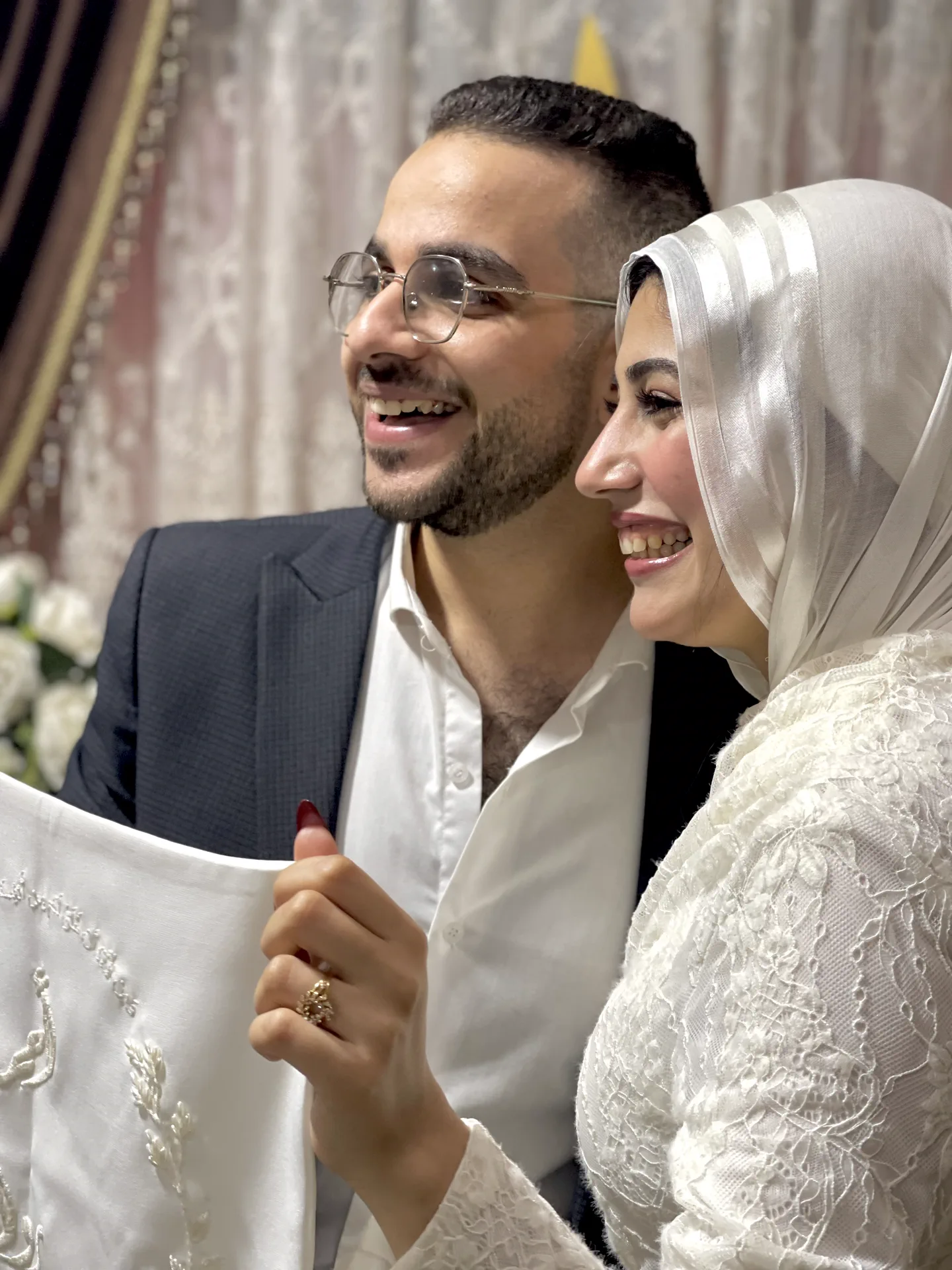 Ahmed and Rawan surrounded by wedding florals